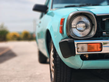 Close-up of car on road