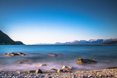 Scenic view of calm sea against clear sky