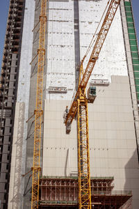 Low angle view of crane at construction site