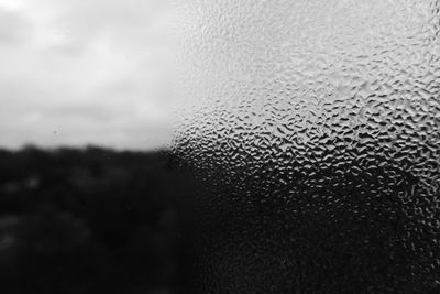 Close-up of raindrops on glass window