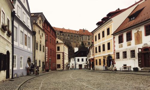 Street amidst buildings against sky