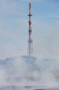 Low angle view of communications tower against sky