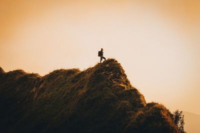 Low angle view of people at sunset