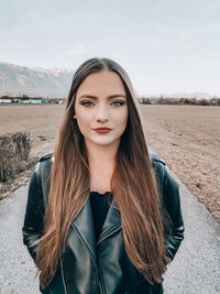 Portrait of beautiful young woman standing outdoors