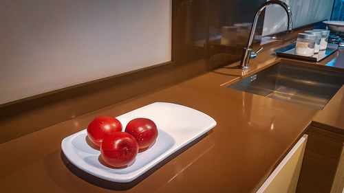 High angle view of apples in plate on table at home