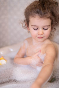 Cute girl bathing in bathroom