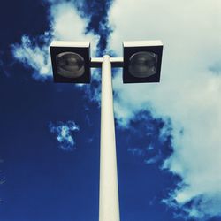 Low angle view of camera against blue sky