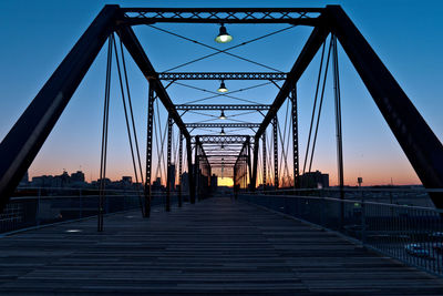 View of suspension bridge against sky during sunset