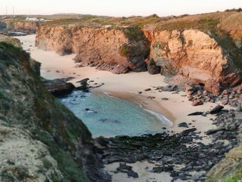 High angle view of rocks on beach against sky