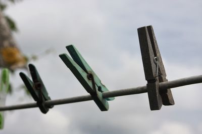 Low angle view of metal against sky