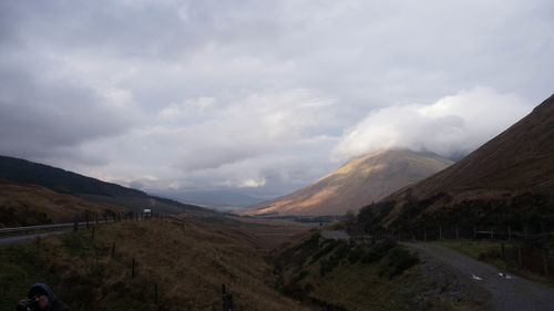 Scenic view of mountains against cloudy sky