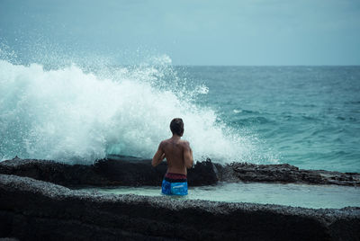 Man standing on beach against sky