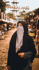 Midsection of woman standing at temple