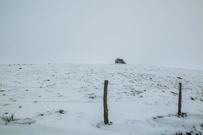 Scenic view of snow covered land against sky