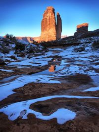 Scenic view of rock formation against sky during winter