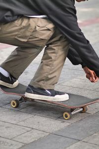 Low section of a man skateboarding