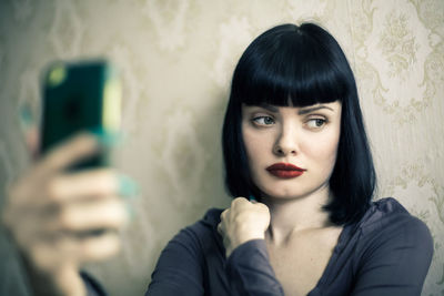 Portrait of young woman using mobile phone