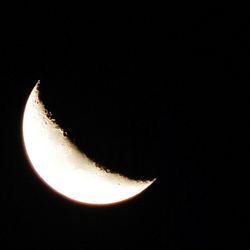 Close-up of illuminated lamp over black background