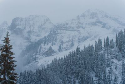 Scenic view of snow covered mountains against sky