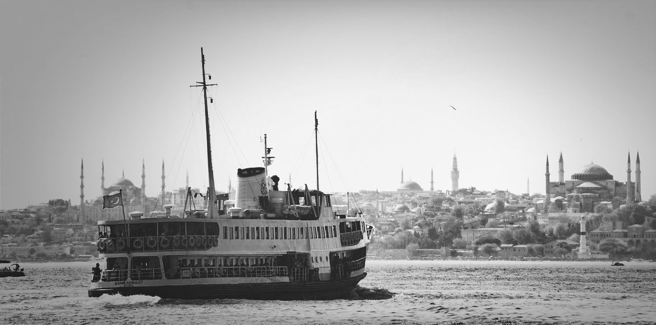 building exterior, nautical vessel, architecture, built structure, water, transportation, clear sky, mode of transport, waterfront, sea, boat, copy space, harbor, river, sailboat, moored, day, city, travel, ship