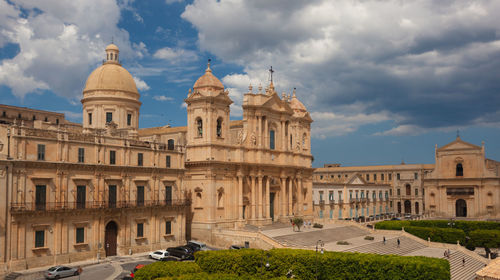 Facade of historic building against cloudy sky