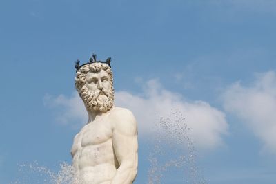 Close up of neptune marble statue located at the piazza della signoria in florence.