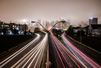 Light trails on road in city at night