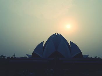 Lotus temple against sky during sunset