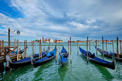 Gondolas and in lagoon of venice by san marco square. venice, italy