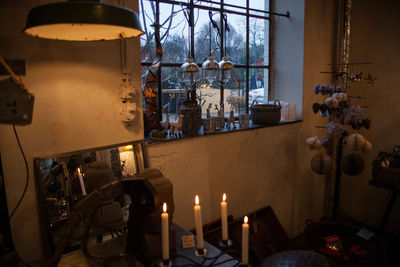 Illuminated lamps on table against building