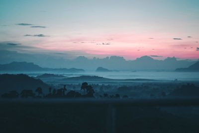 Scenic view of silhouette mountains against sky during sunset