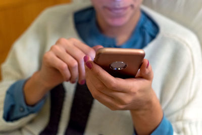 Midsection of woman using mobile phone