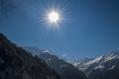 Low angle view of snowcapped mountain against sky