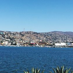 View of cityscape against clear blue sky