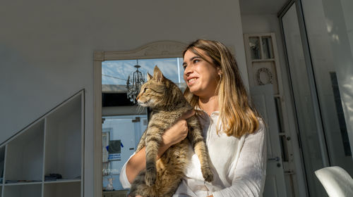 Portrait of a young woman with cat