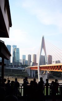 People on city buildings against sky