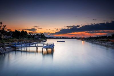 Scenic view of swimming pool against sky during sunset