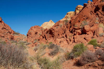 Rock formations on landscape against clear sky