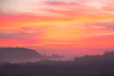Scenic view of silhouette landscape against romantic sky at sunset