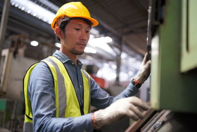 Portrait of man working at construction site