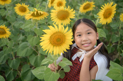 Portrait of girl holding sunflower
