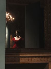 Rear view of a woman sitting in corridor