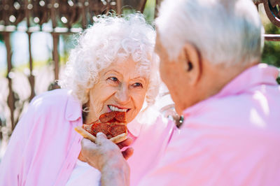 Side view of senior woman holding hands
