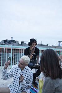 Friends hanging out on a building rooftop