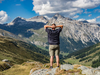 Full length of man standing on mountain against sky