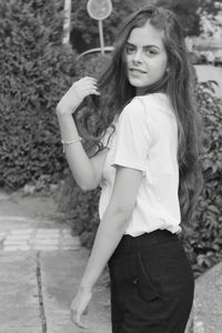 Portrait of smiling young woman standing outdoors