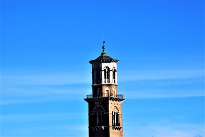 Low angle view of clock tower against blue sky