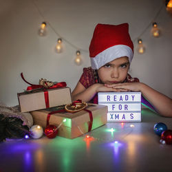 Girl in red santa hat waiting for christmas season