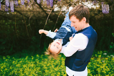 Father playing with son on field