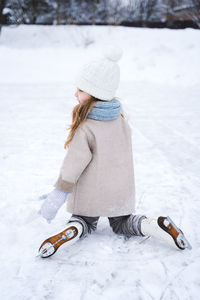 Full length of woman wearing hat in snow